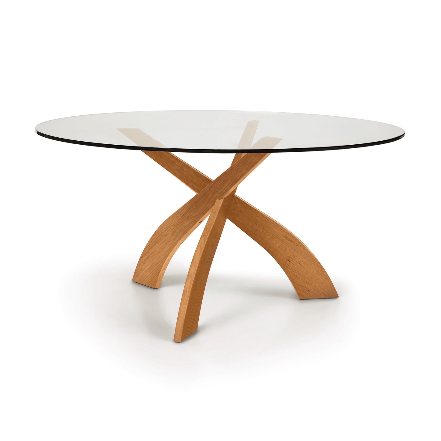 Entwine Round Glass Top Dining Table by Copeland Furniture with three interlocking cherry wood legs and modern, minimalist style.