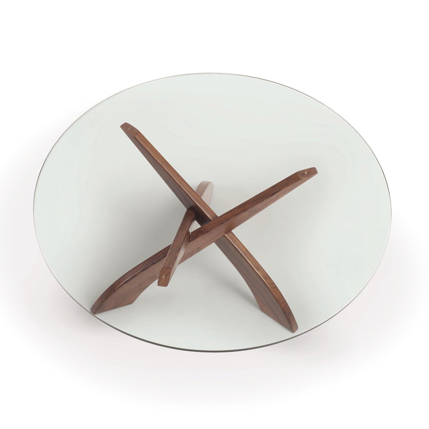 Entwine Round Coffee Table by Copeland Furniture featuring a clear glass top and striking sculptural walnut base with three gracefully curved intersecting legs.