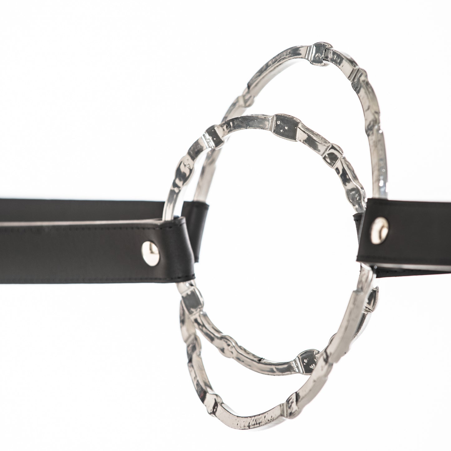 Equus Console Table by Hubbardton Forge with artisanal leather belts and silver rings on display.