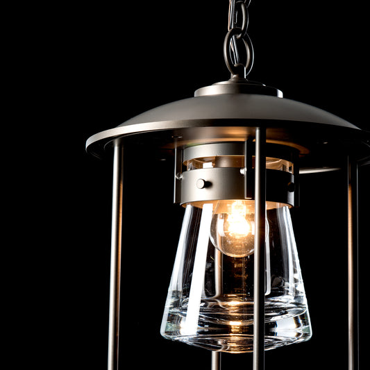 Hubbardton Forge Erlenmeyer Outdoor Pendant featuring handcrafted American-made design, clear glass shade, and glowing bulb highlighting fine craftsmanship.