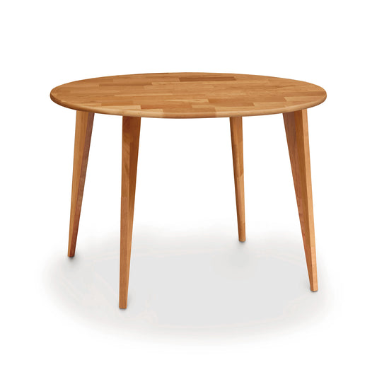 A Copeland Furniture Essentials Round Dining Table with Wood Legs crafted from sustainably harvested wood on a white background.