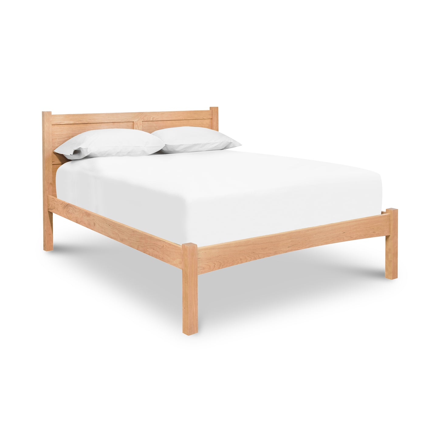 A Essex Low Footboard Bed, crafted from solid hardwoods by Vermont Furniture Designs, with a white mattress and pillows against a white background.