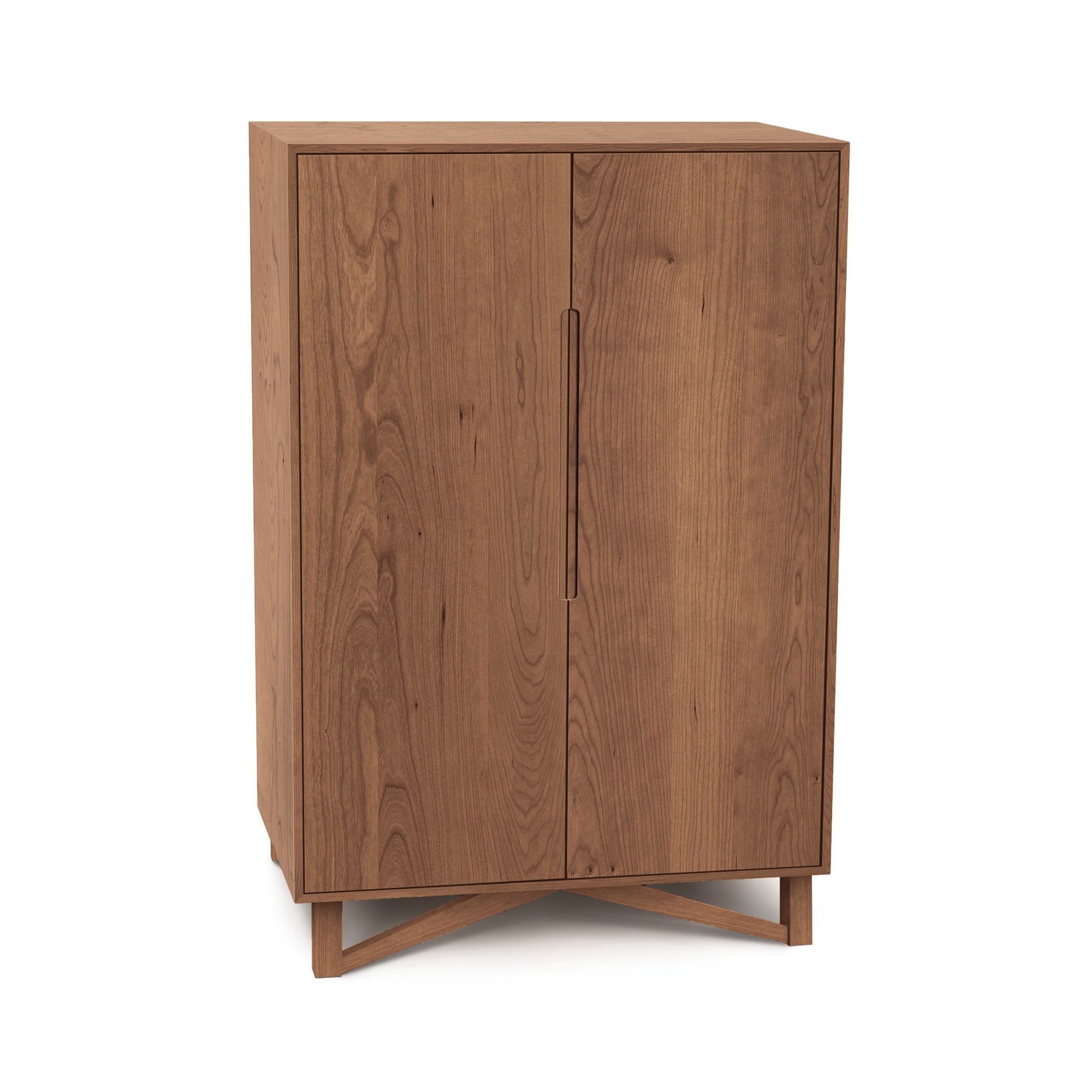 Exeter Bar Cabinet by Copeland Furniture featuring a handcrafted mid-century style, two vertical doors, and a distinctive cross-shaped base.