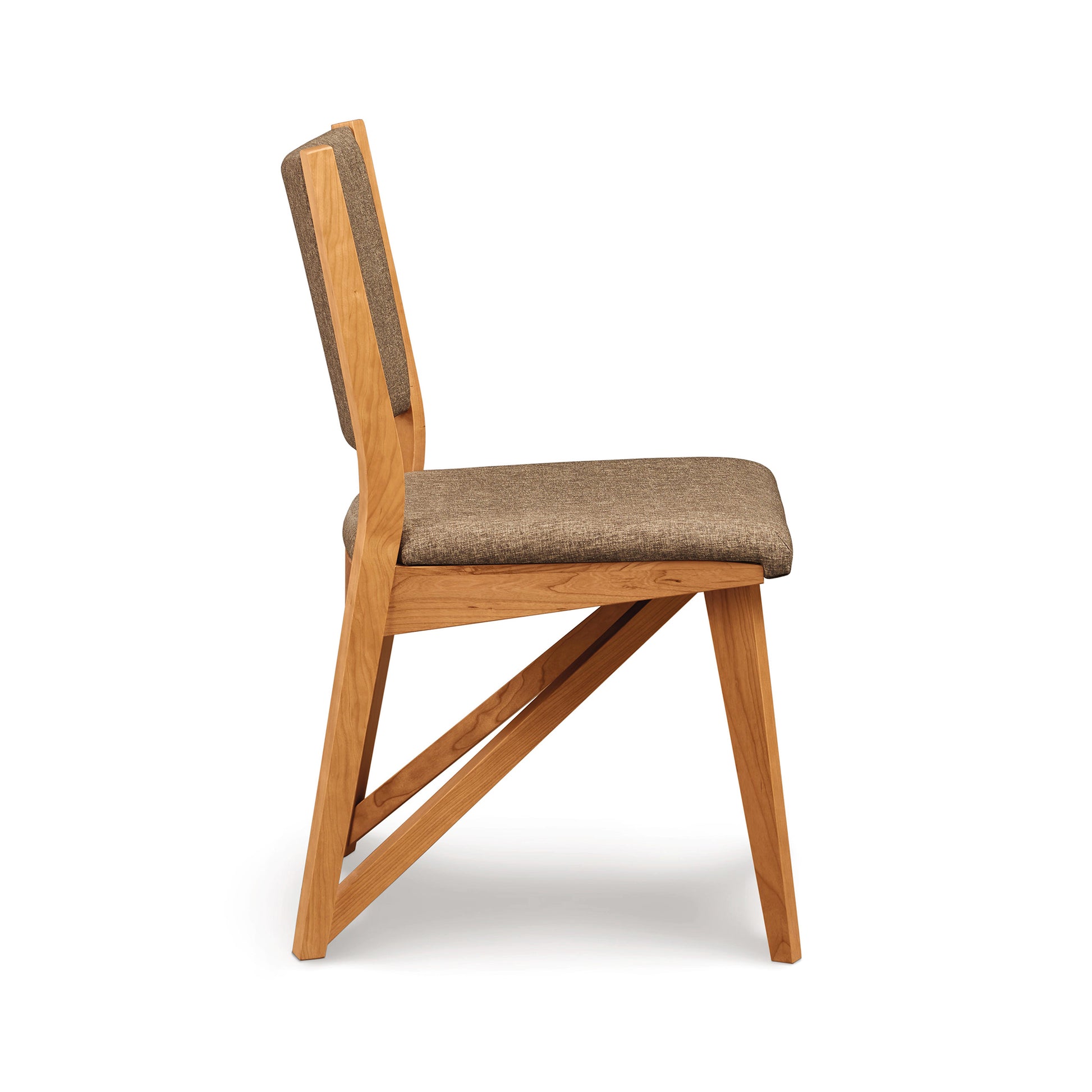 Exeter Chair by Copeland Furniture featuring modern angular legs and a beige upholstered seat, highlighting its contemporary design.