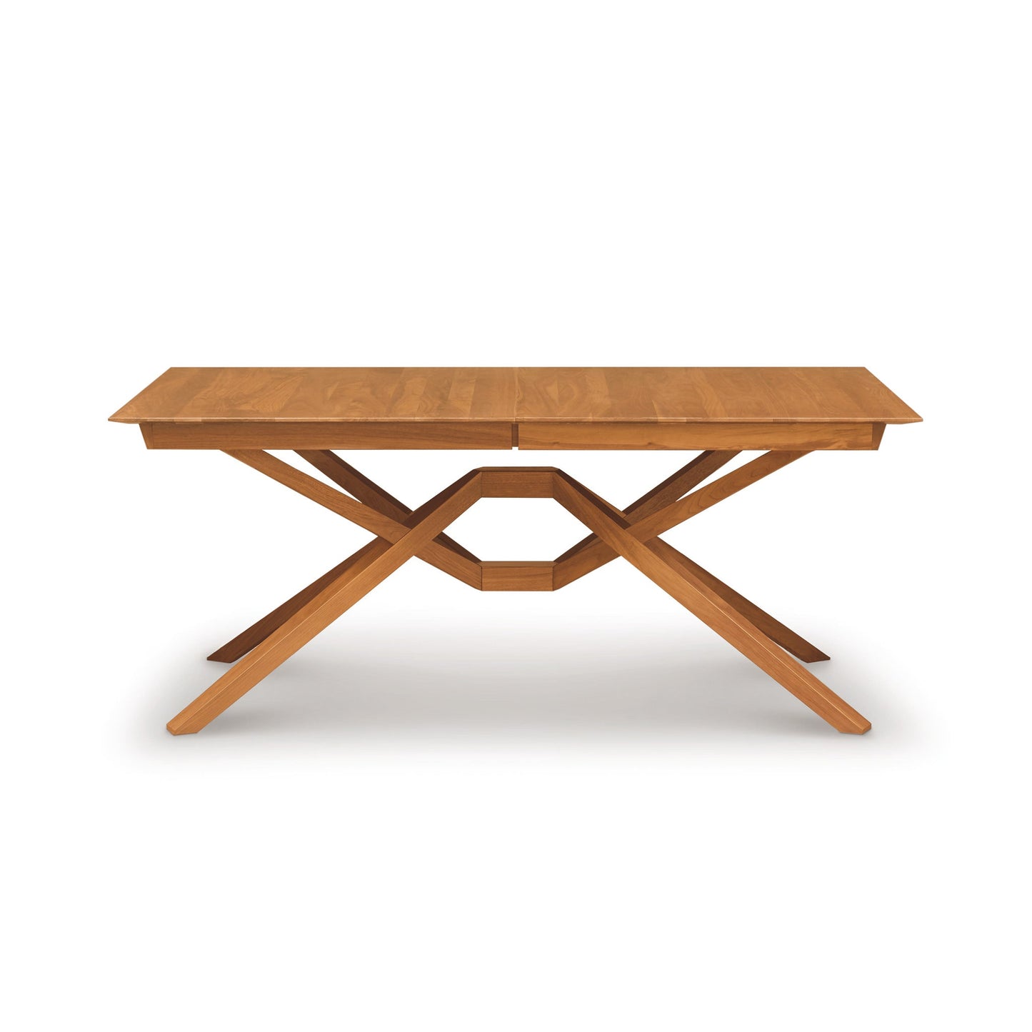 A wooden table with a cross leg on it.