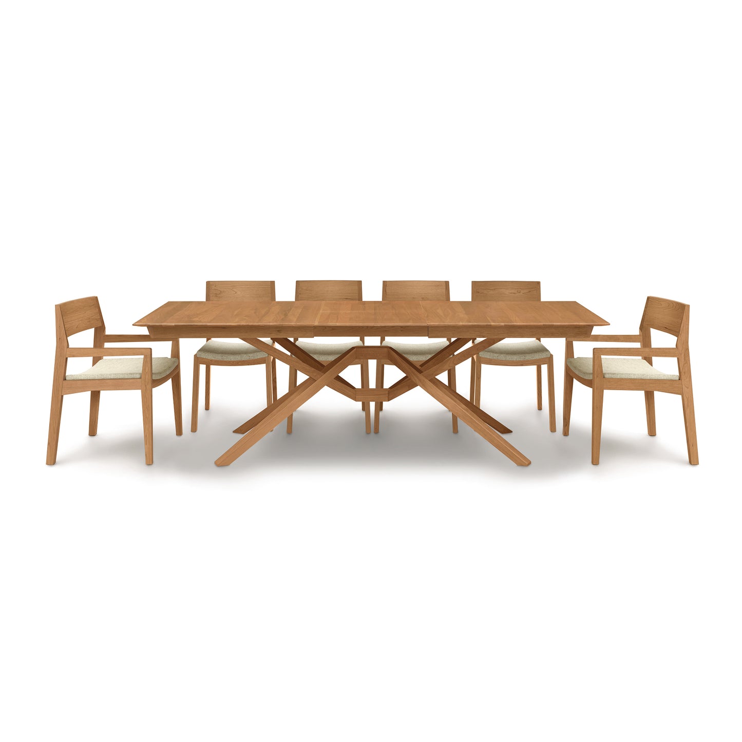 A Copeland Furniture Exeter Extension Dining Table set with six chairs and a butterfly leaf extension on a white background.