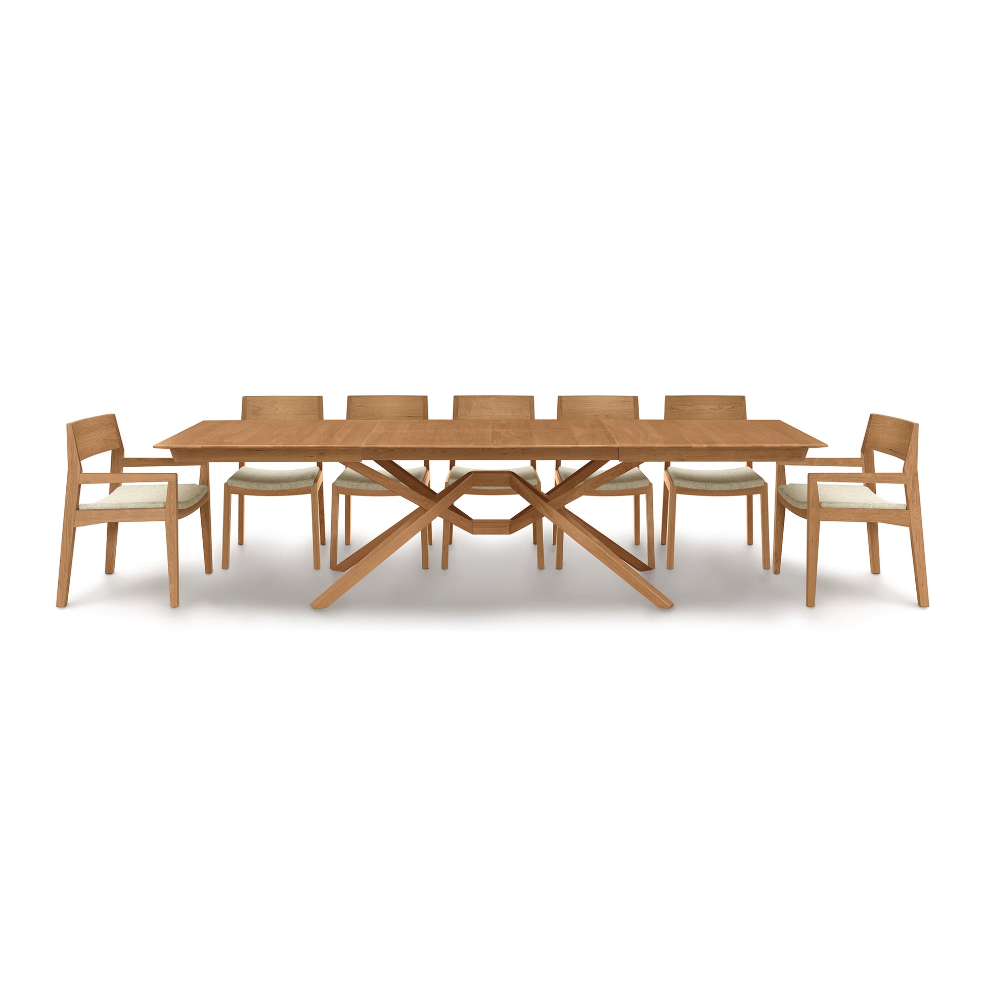 An Exeter Extension Dining Table set with eight chairs, featuring a butterfly leaf extension, on a white background by Copeland Furniture.