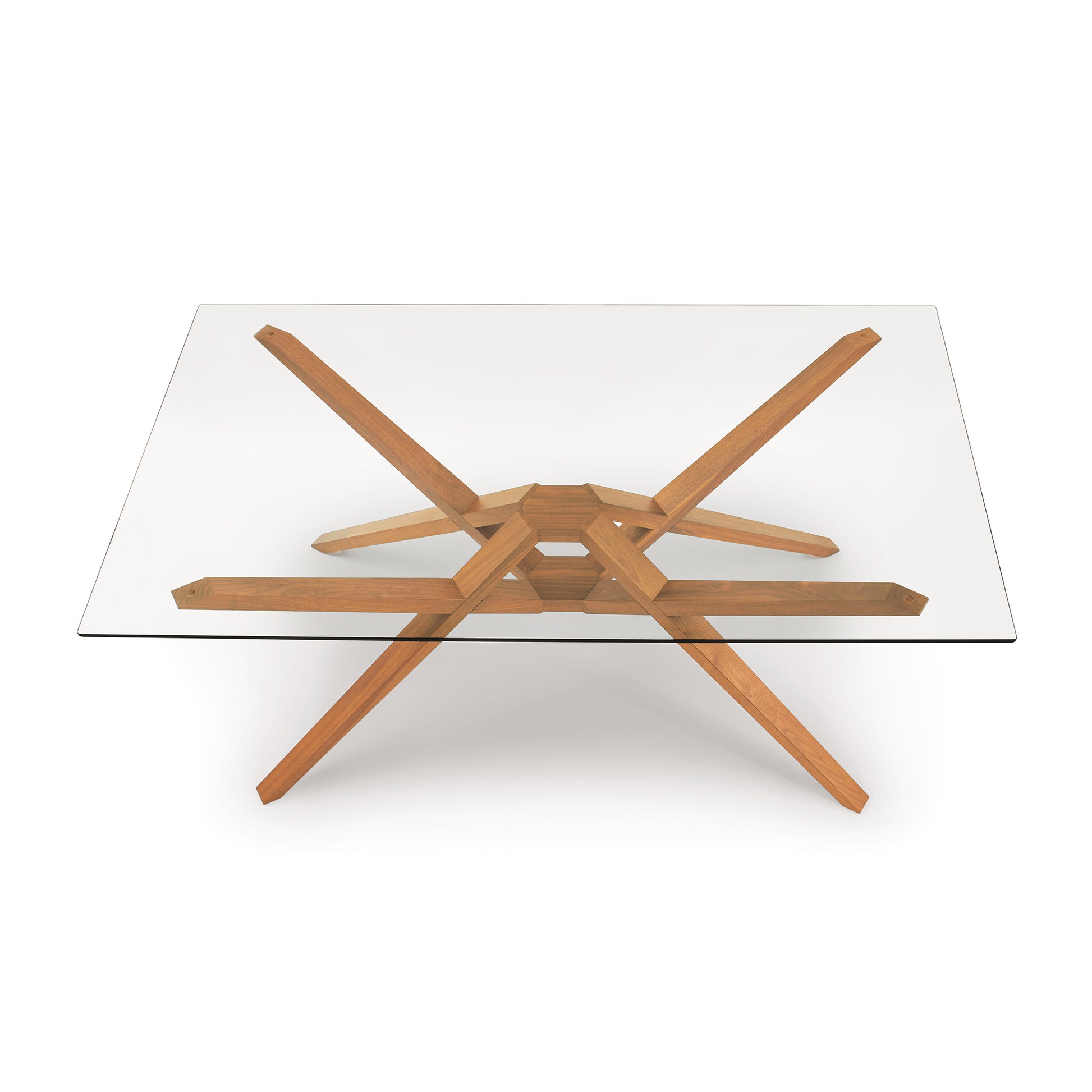 Exeter Rectangular Glass Top Table by Copeland Furniture with modern angled hardwood legs, highlighting craftsmanship and sleek design.