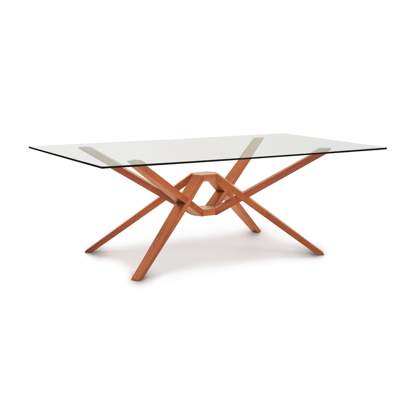 An Exeter Rectangular Glass Top Table crafted by Copeland Furniture, featuring a solid wood interlocking base structure on a white background.