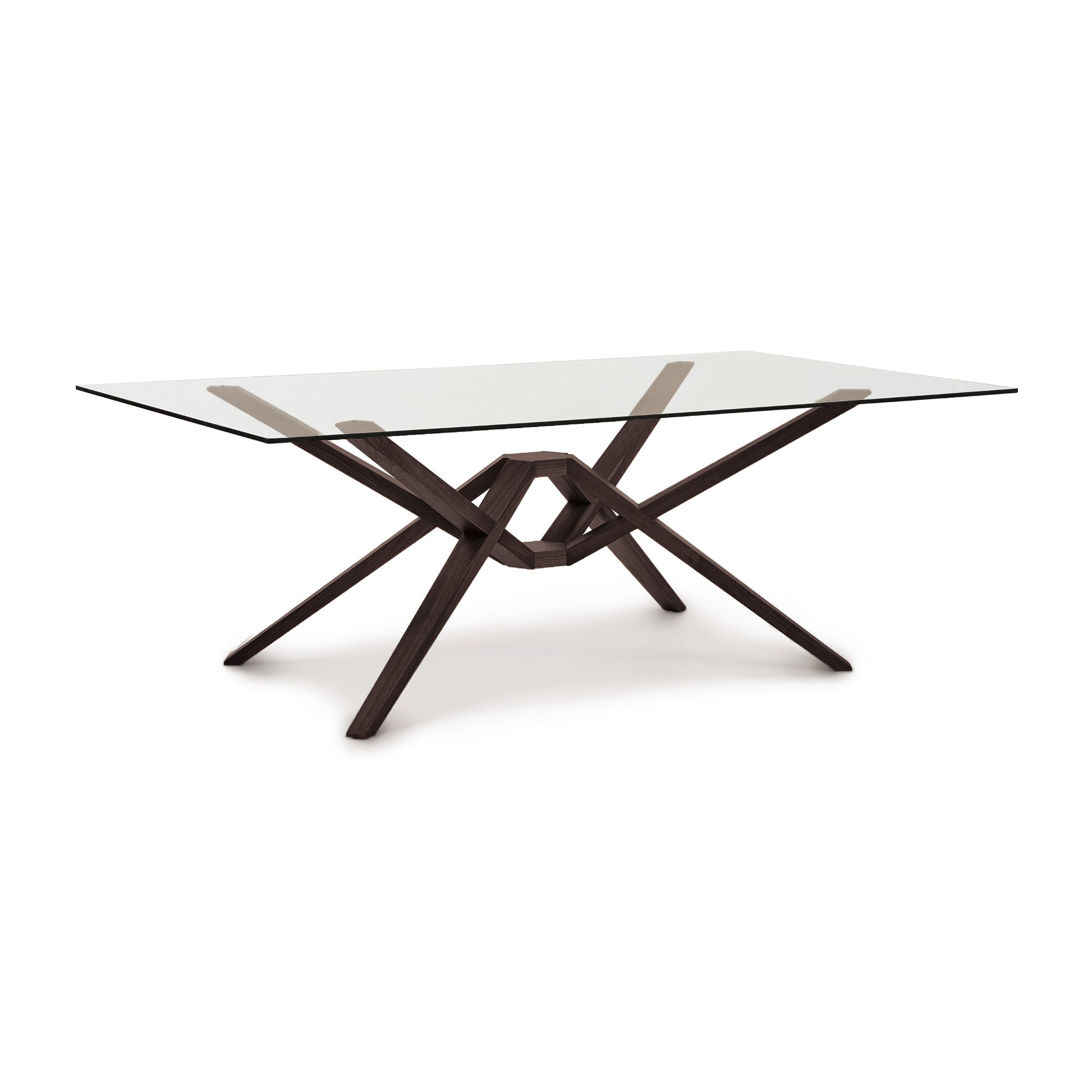 A modern Copeland Furniture Exeter Rectangular Glass Top Table with a wooden base featuring an intricate cross and overlap design, isolated on a white background.