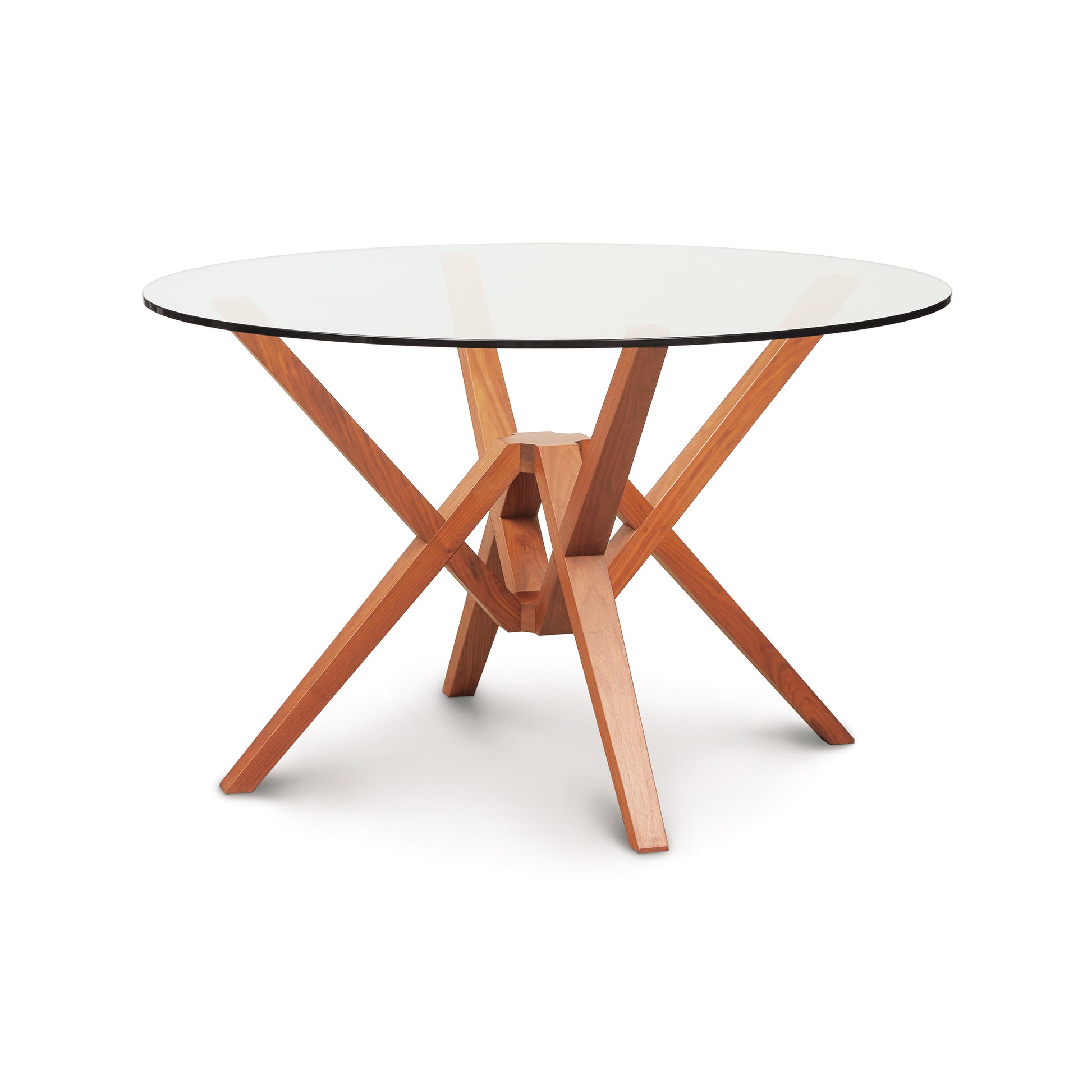 Exeter Round Glass Top Table by Copeland Furniture with a striking geometric hardwood base and clear round glass top, showcasing modern American craftsmanship.