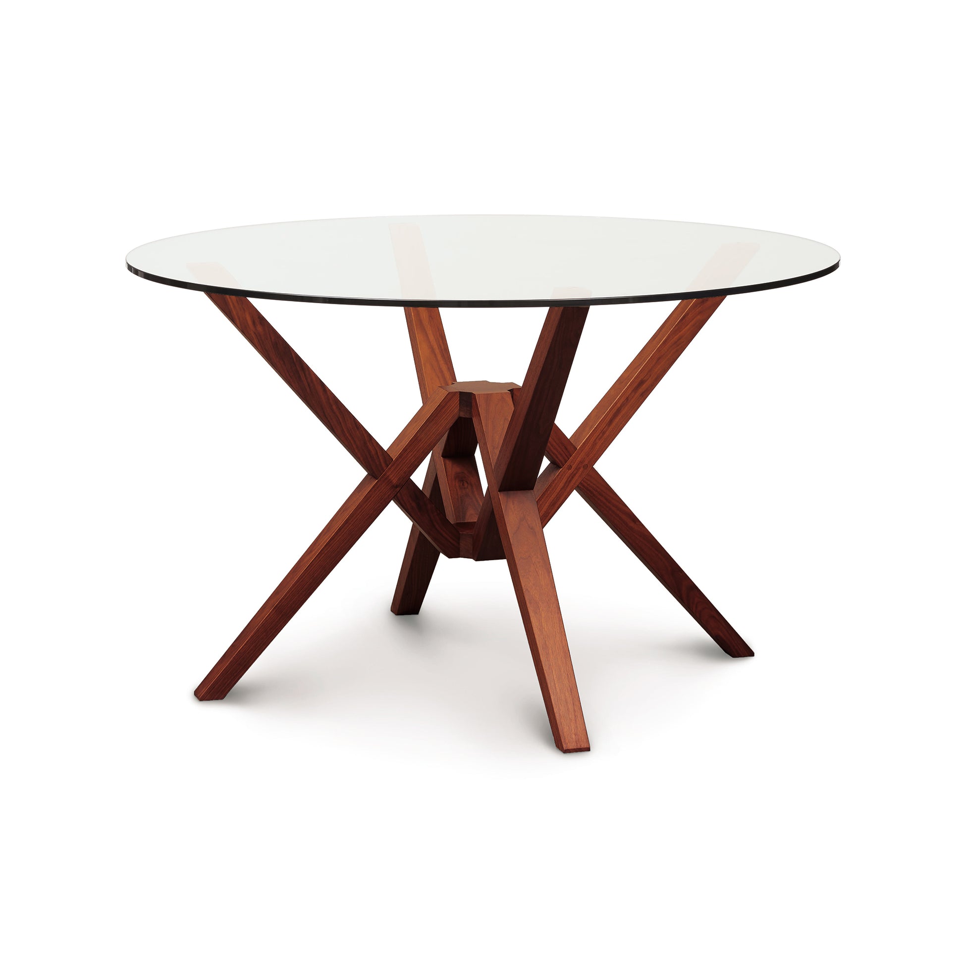 Exeter Round Glass Top Table by Copeland Furniture featuring a striking geometric hardwood base with intersecting legs and a clear round glass tabletop.