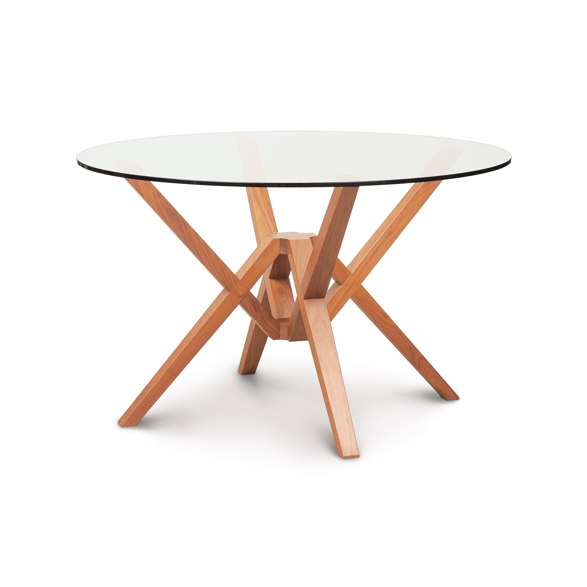 Copeland Furniture's Exeter Round Glass Top Table with a sustainably harvested hardwoods base featuring an intersecting legs design.