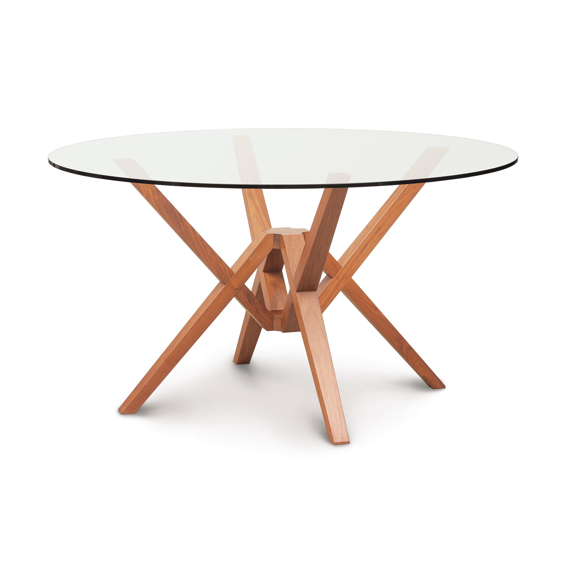 Exeter Round Glass Top Table by Copeland Furniture with a striking geometric hardwood base displayed prominently.