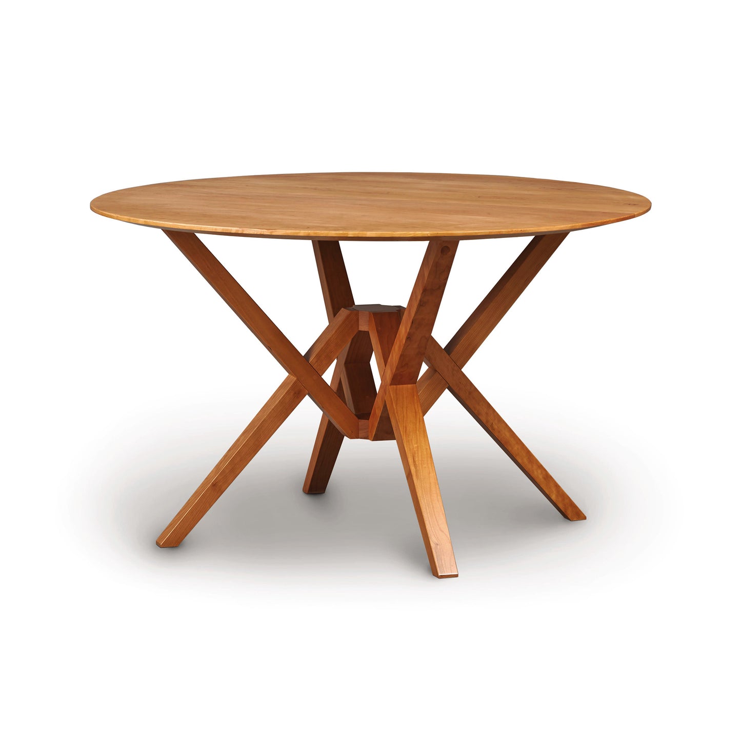 Exeter Round Dining Table by Copeland Furniture, crafted from sustainable hardwood with distinctive angled legs, elegantly displayed.