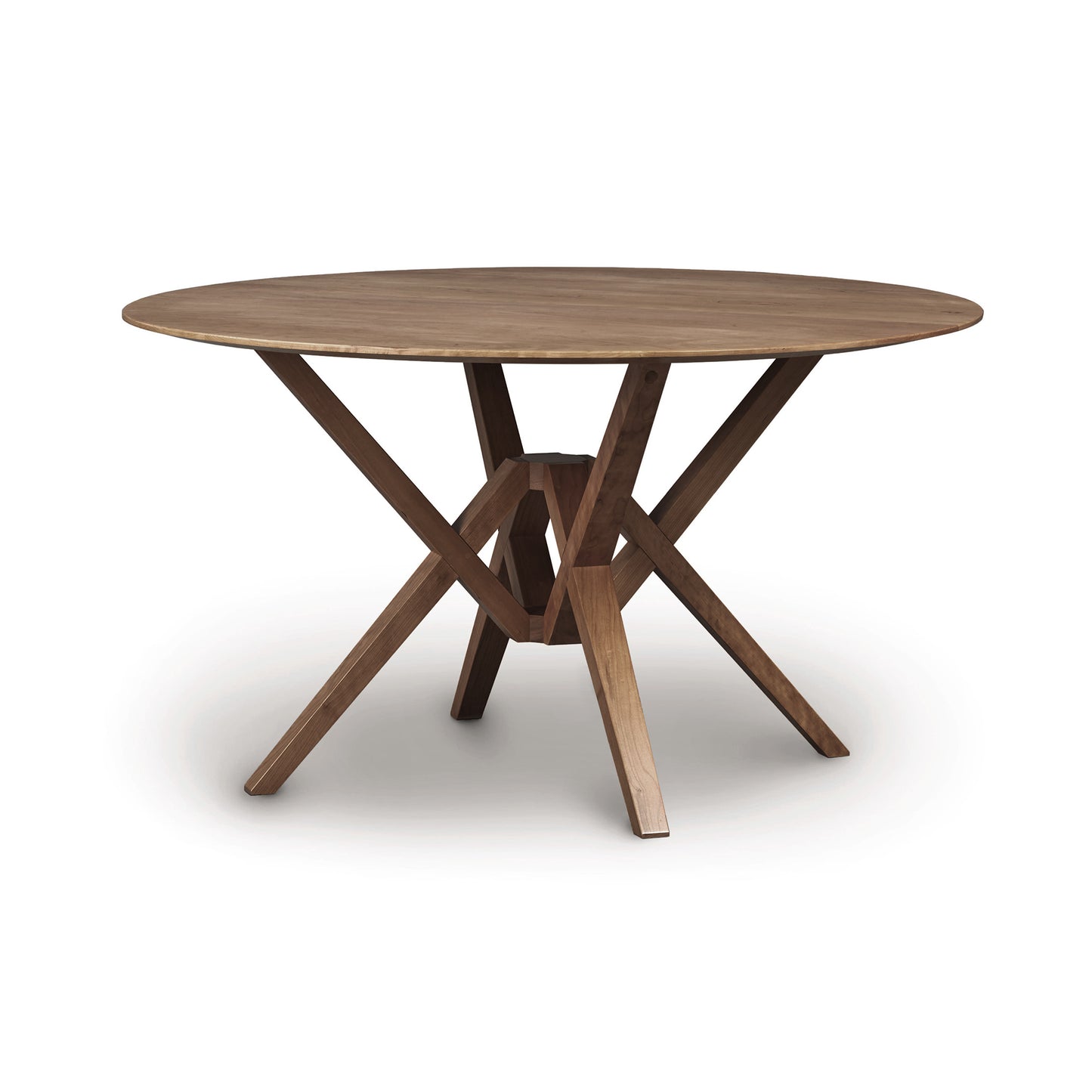 An Exeter Round Solid Top Dining Table crafted from sustainably harvested hardwoods, featuring a cross-shaped base on a white background by Copeland Furniture.