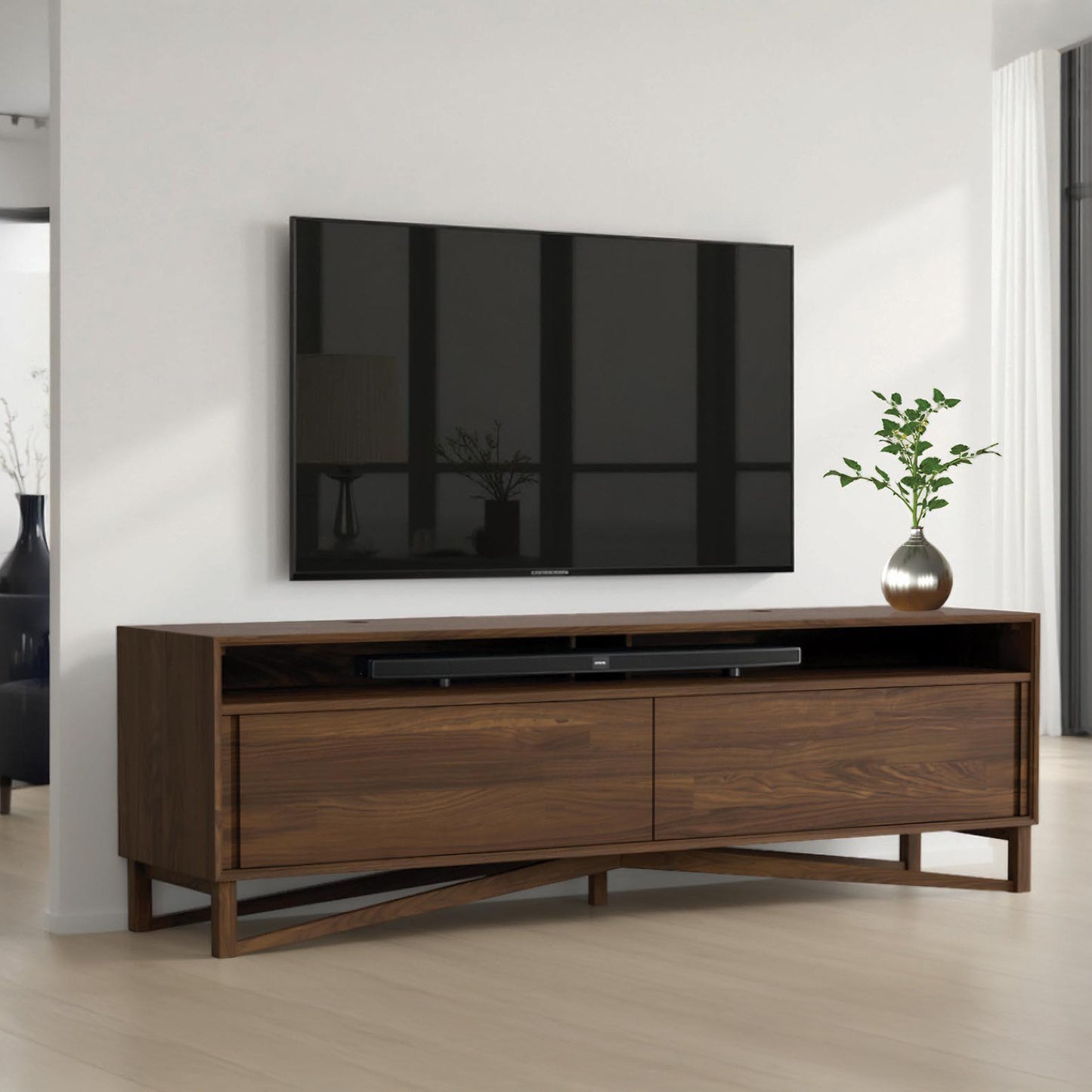 Copeland Furniture Exeter Media Cabinet showcased beneath a wall-mounted TV, highlighting its quality craftsmanship and modern design.