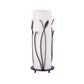 A Hubbardton Forge Forged Leaves and Glass Table Lamp with a black base and a white shade.