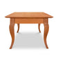 A French Country Coffee Table by Lyndon Furniture, with a curved leg.