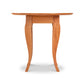 A French country-inspired round end table with a wooden top and legs, part of the Lyndon Furniture collection.
