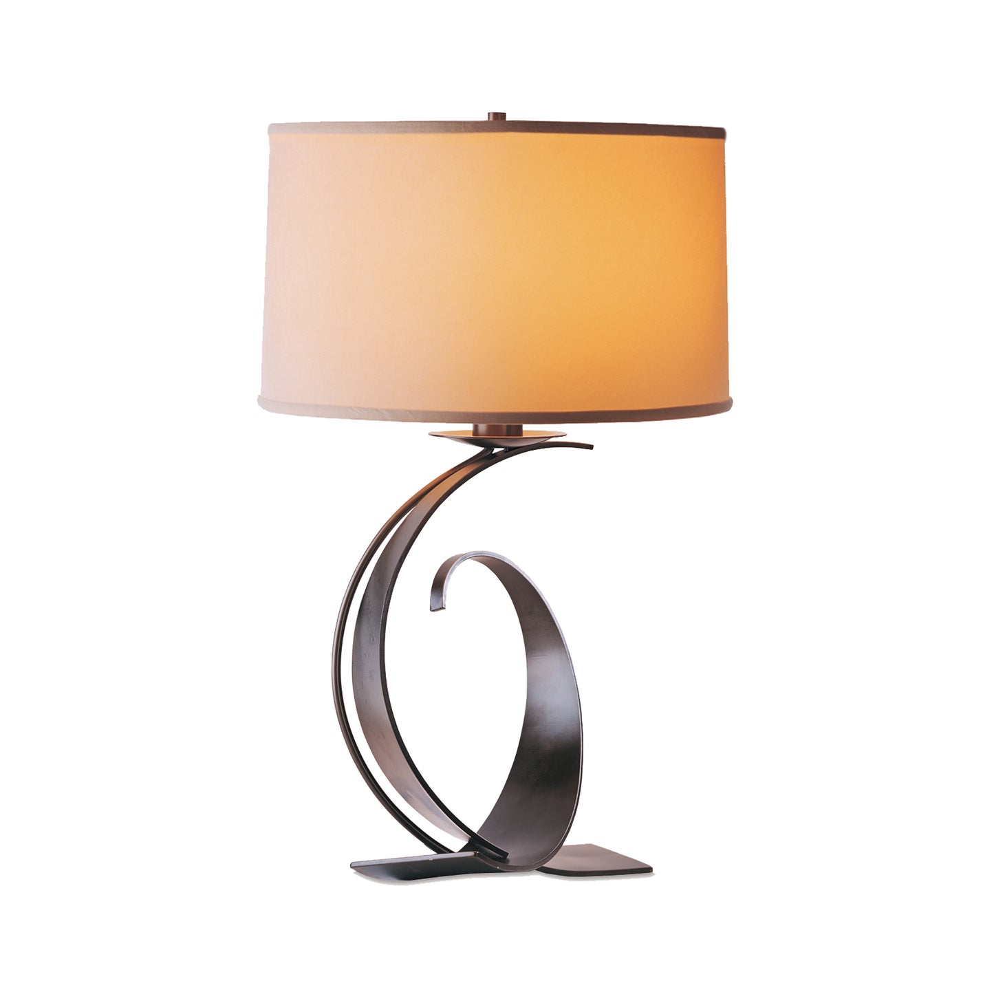Fullered Impressions Table Lamp by Hubbardton Forge with a beige cylindrical shade and an elegant metallic spiral base.