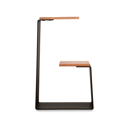 G Table by Vermont Woods Studios with a black metal frame and two staggered hardwood surfaces in a modern geometric design.