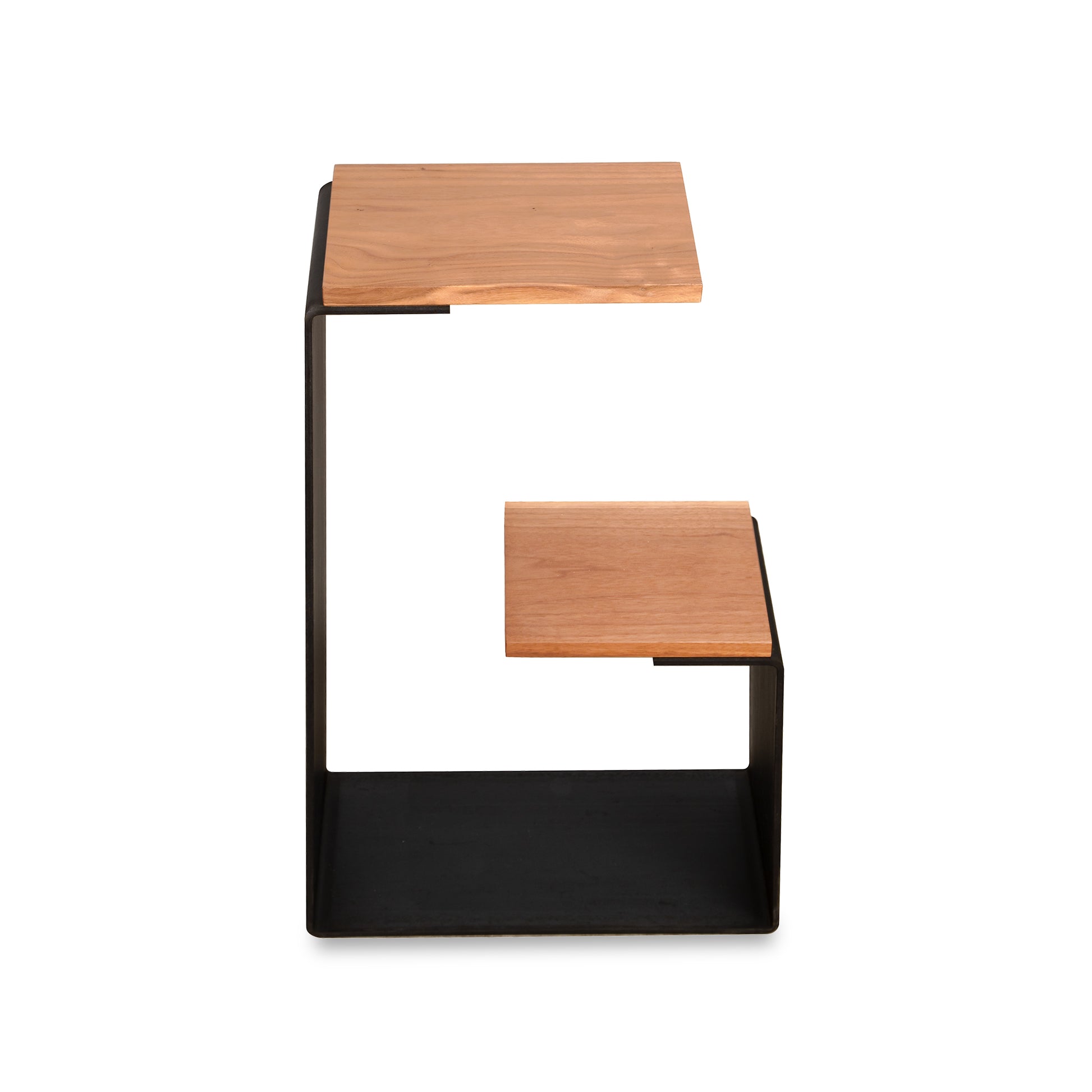 G Table by Vermont Woods Studios showcasing a black metal frame and two geometric, stepped hardwood shelves in a modern design.