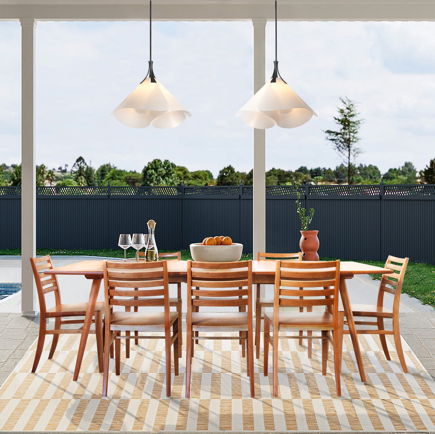 Eight Grafton Chairs by Vermont Woods Studios encircle a solid wood dining table, showcasing American-made craftsmanship and quality furniture design.