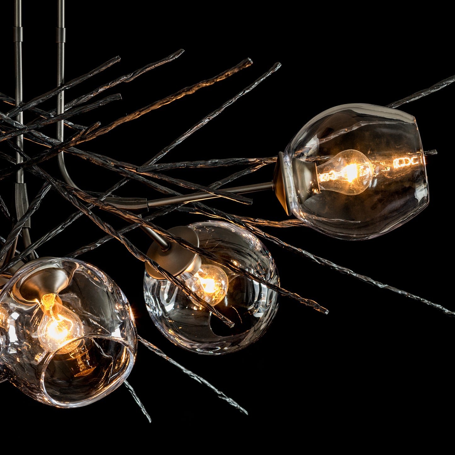 Hubbardton Forge Griffin Pendant featuring three glass sphere lights and elegant metal branch design.