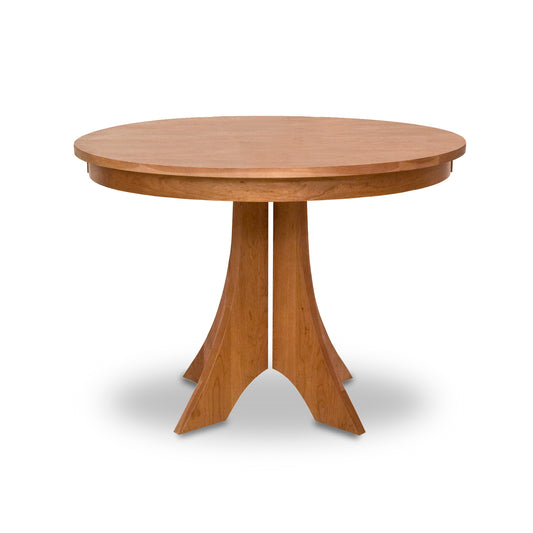 Hampton Split Pedestal Round Table by Lyndon Furniture with a round wood top and four angled legs, highlighting its craftsmanship and elegant design.