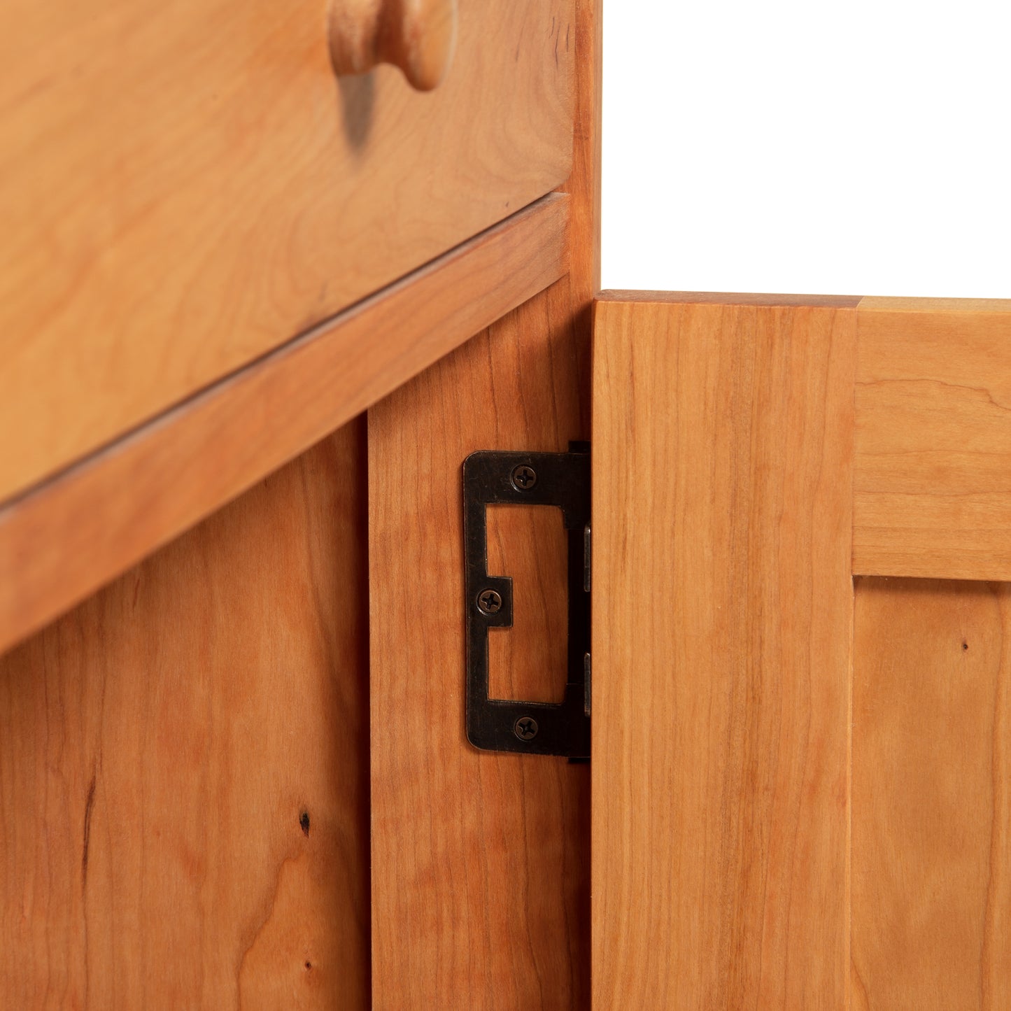 Detail view of the Heartwood Shaker 1-Drawer Nightstand with Door, highlighting its quality metal hinge craftsmanship by Vermont Furniture Designs.