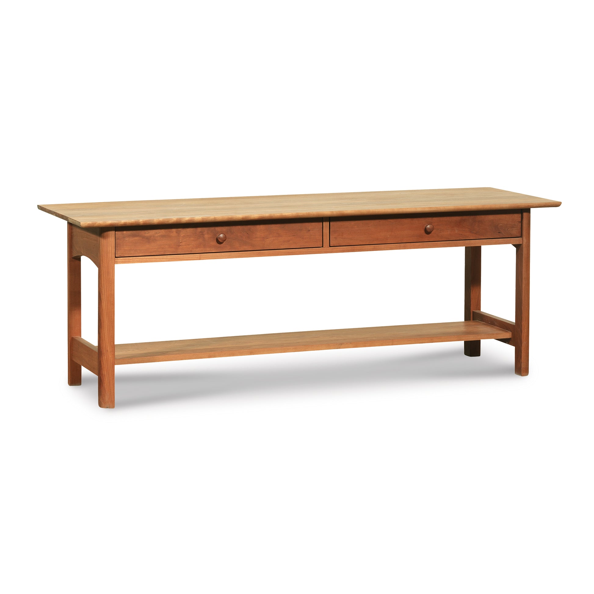 A Heartwood Shaker 2-Drawer Coffee Table by Vermont Furniture Designs with a lower shelf on a plain background.
