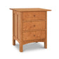 An eco-friendly Heartwood Shaker 3-Drawer Nightstand by Vermont Furniture Designs isolated on a white background.