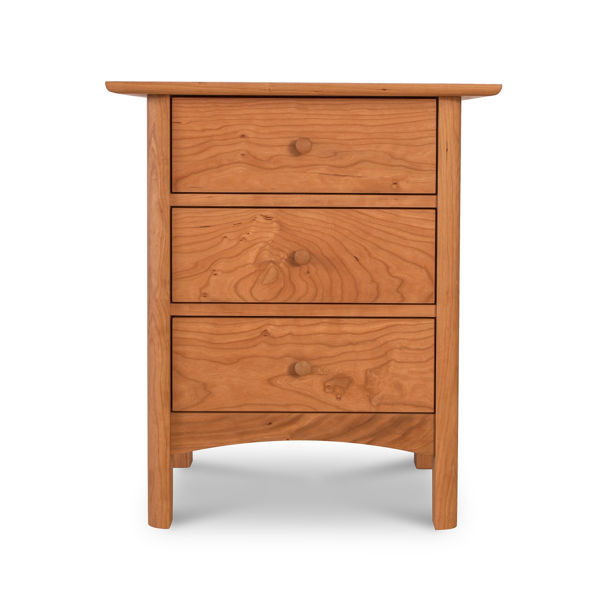 A wooden Heartwood Shaker 3-Drawer Nightstand from Vermont Furniture Designs isolated on a white background.