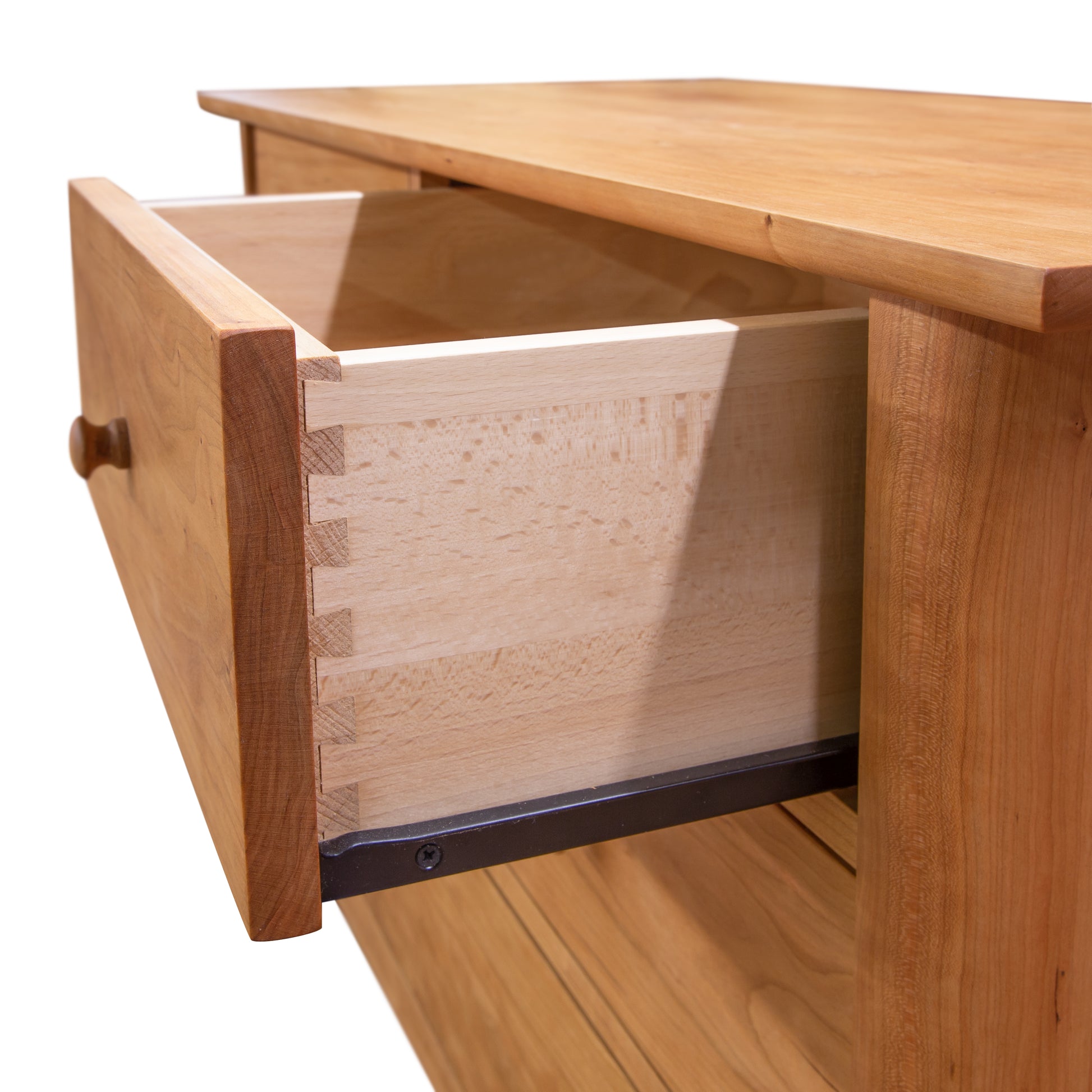 An open empty Heartwood Shaker 4-Drawer Dresser drawer, showing dovetail joinery on a light background.