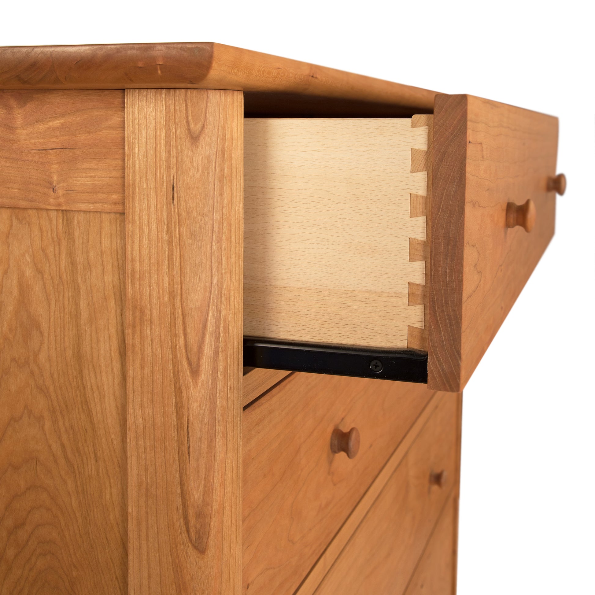A Vermont Furniture Designs Heartwood Shaker 5-Drawer Chest with one open drawer showing dovetail joinery.