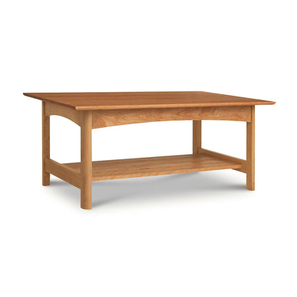 A handmade solid wood Vermont Furniture Designs Heartwood Shaker Coffee Table with a lower shelf on a white background.