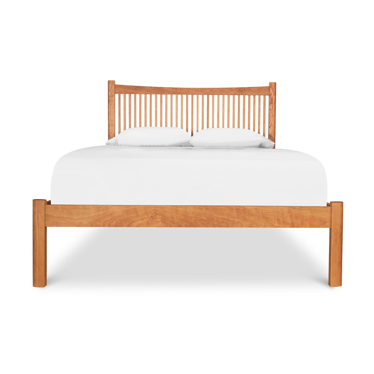 A Heartwood Shaker Low Footboard Bed by Vermont Furniture Designs with Arts and Crafts styling, featuring a white mattress and two pillows against a white background.