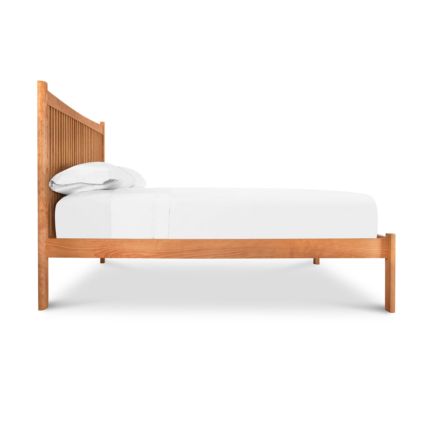 Vermont Furniture Designs Heartwood Shaker Low Footboard Bed featuring a tall slatted headboard with an eco-oil finish and white bedding.
