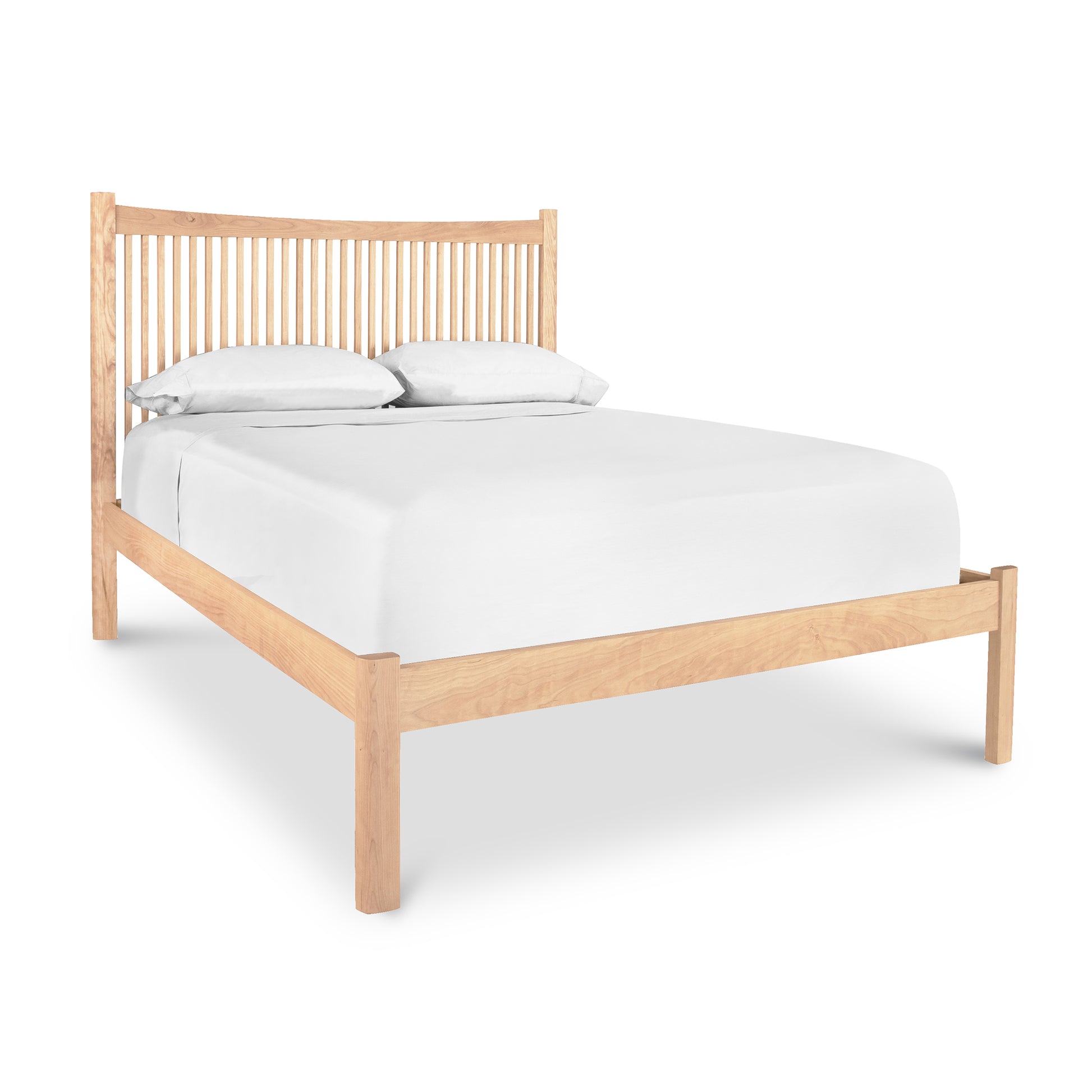 A Heartwood Shaker Low Footboard Bed frame featuring a headboard with vertical slats, supporting a white mattress with two pillows, isolated on a white background.Designed by Vermont Furniture Designs.