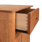 A Heartwood Shaker Short Storage Chest by Vermont Furniture Designs, partially open, showcasing its dovetail joint construction and a glimpse of the interior.