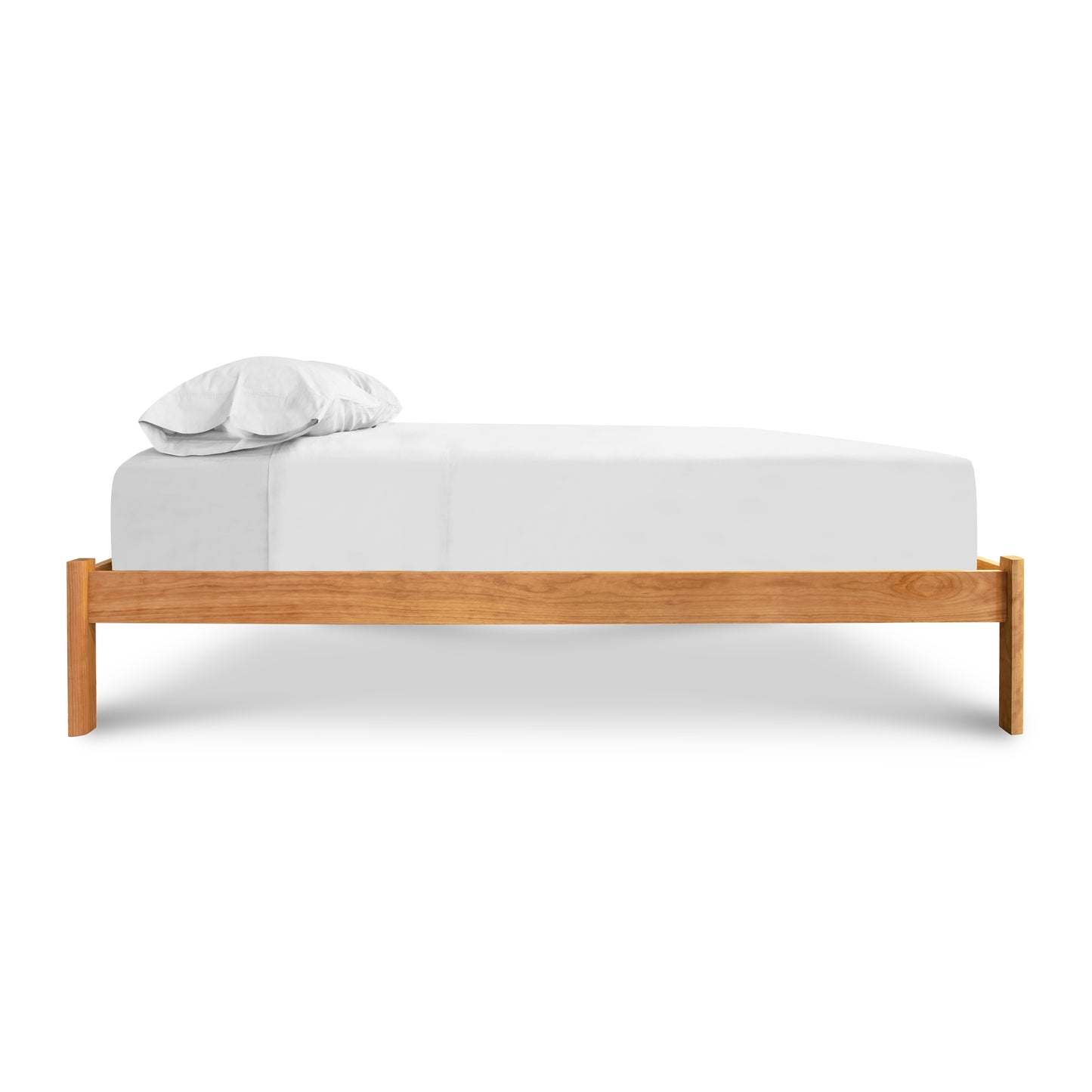 Vermont Furniture Designs Heartwood Shaker Studio-Style Platform Bed featuring a minimalist, elegant design with a white sheet and pillow.