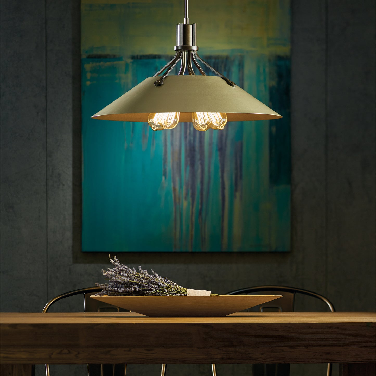 Hubbardton Forge Henry Pendant with exposed bulbs illuminating a beautifully crafted wooden table.