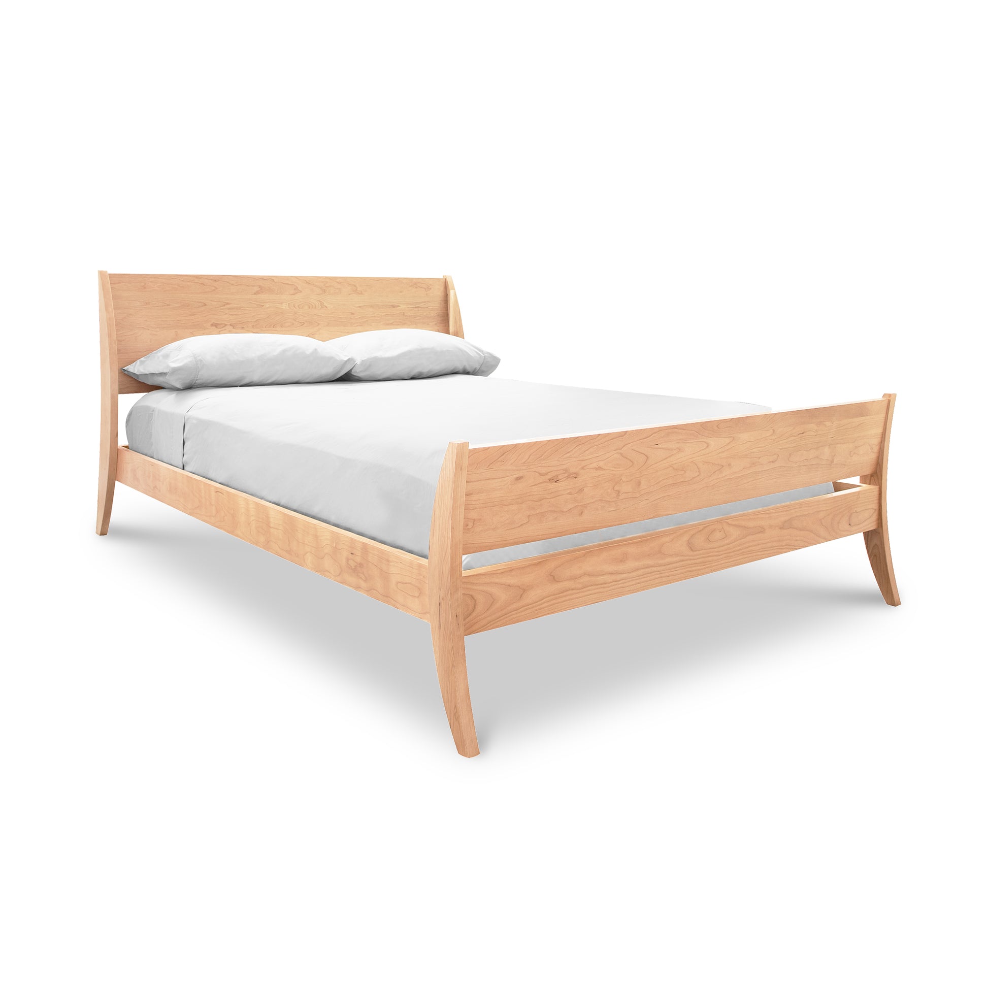 The Lyndon Furniture Holland Sleigh Bed, an elegant bedroom centerpiece, features a contemporary twist with a white sheet adorning its wooden frame.