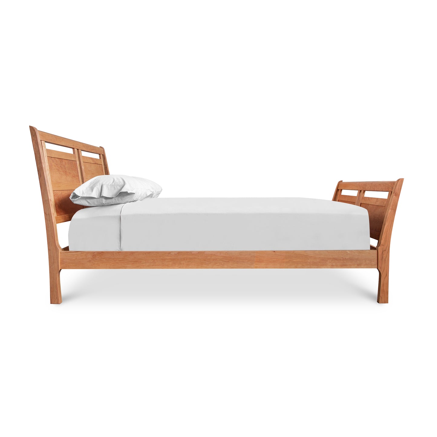 A handcrafted Vermont Furniture Designs Incline Sleigh Bed with a white mattress and a single pillow against a white background.