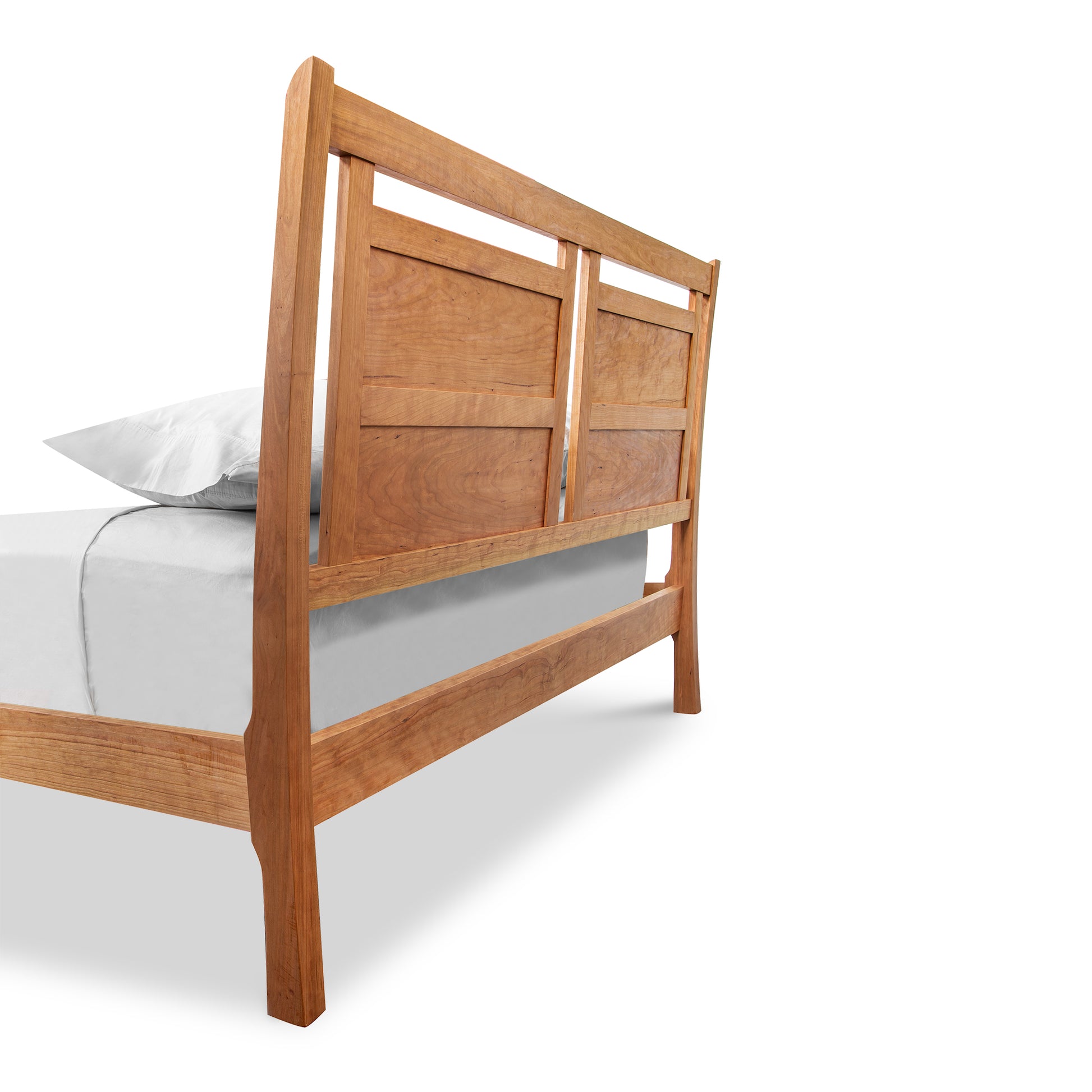 Handcrafted Vermont Furniture Designs Incline Sleigh Bed with a headboard, partially dressed with a fitted sheet and a single pillow, against a white background.