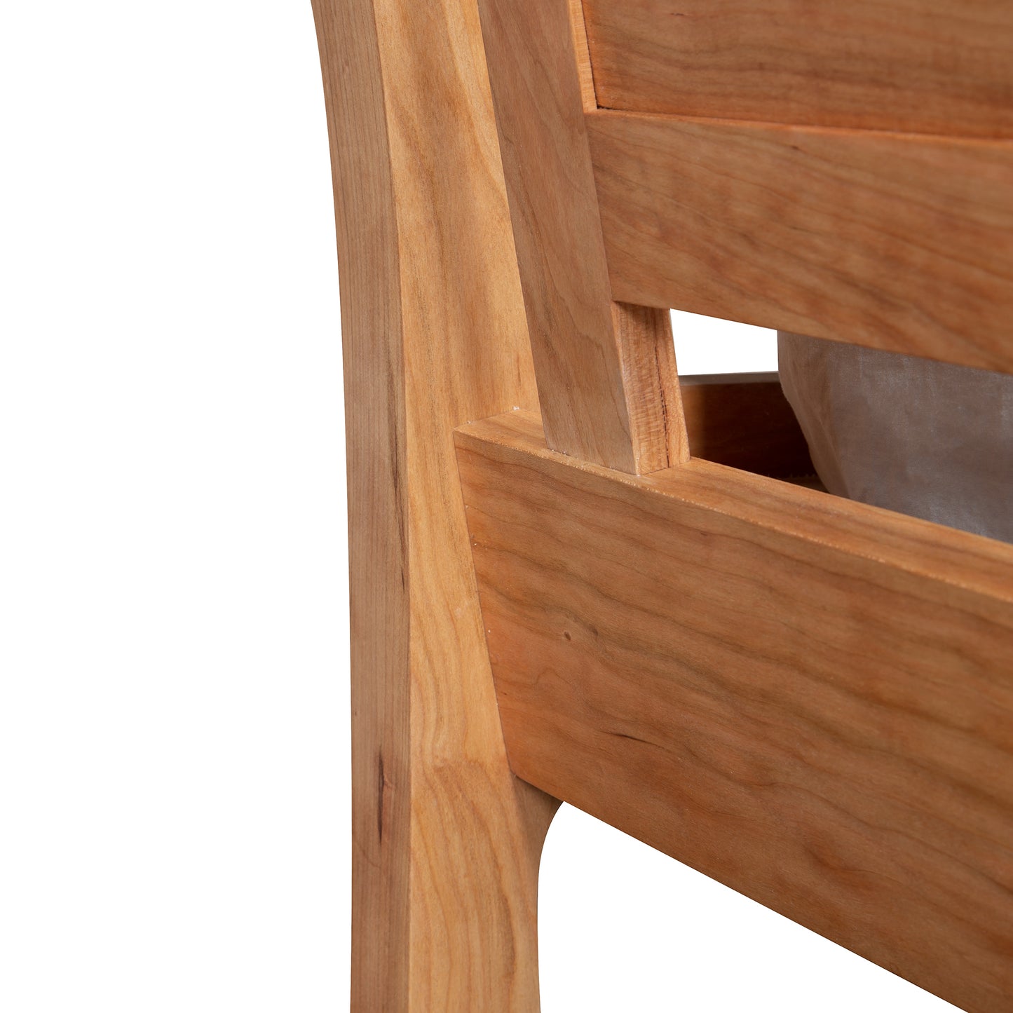 Close-up of a Vermont Furniture Designs Incline Sleigh Bed featuring vertical slats and natural finish.