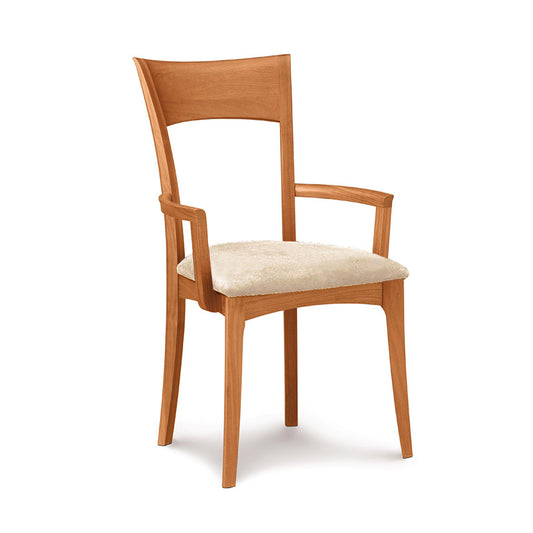 A wooden chair with a beige upholstered seat.