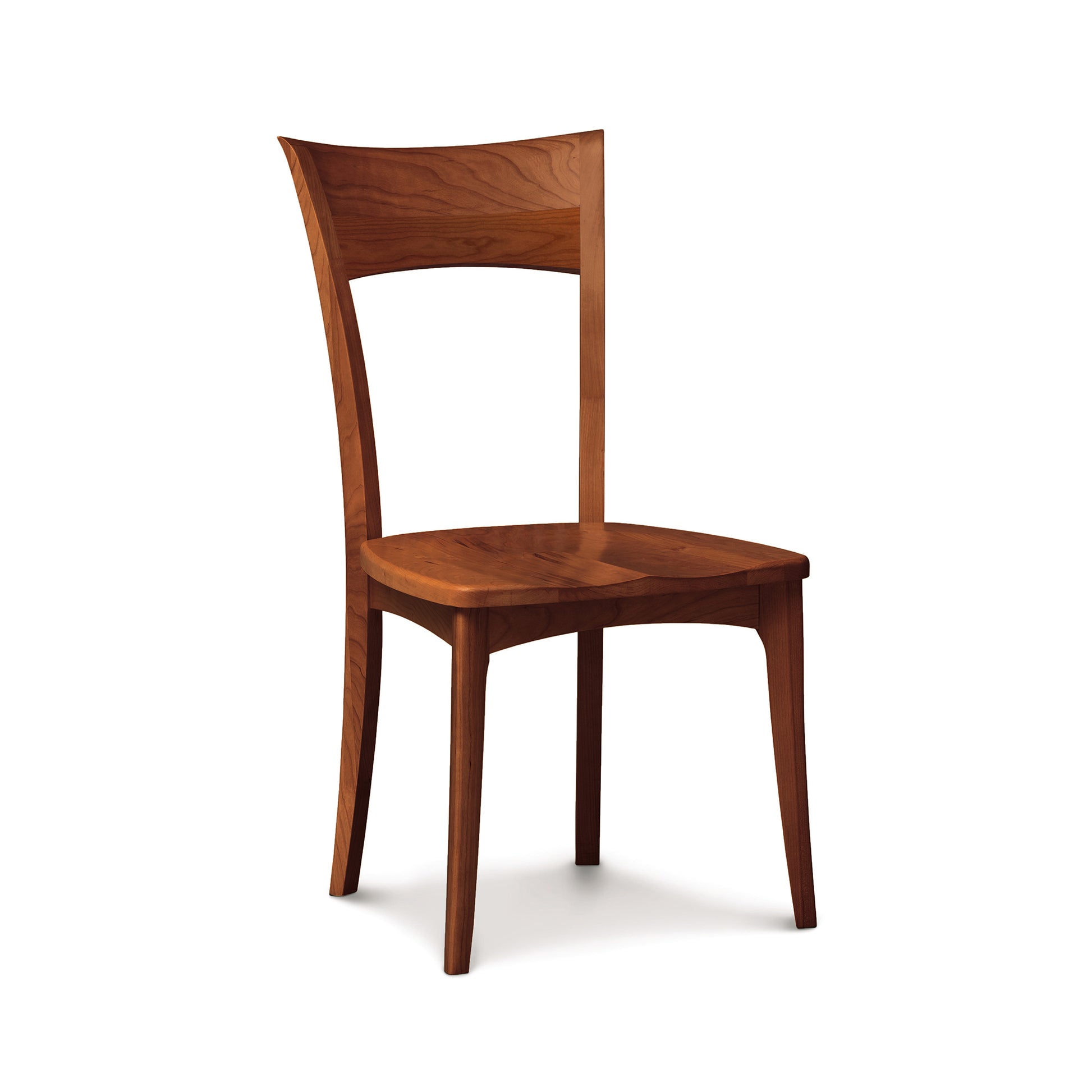 A custom fine dining Ingrid Shaker Chair with Wood Seat made of American cherry wood with a curved backrest isolated on a white background by Copeland Furniture.