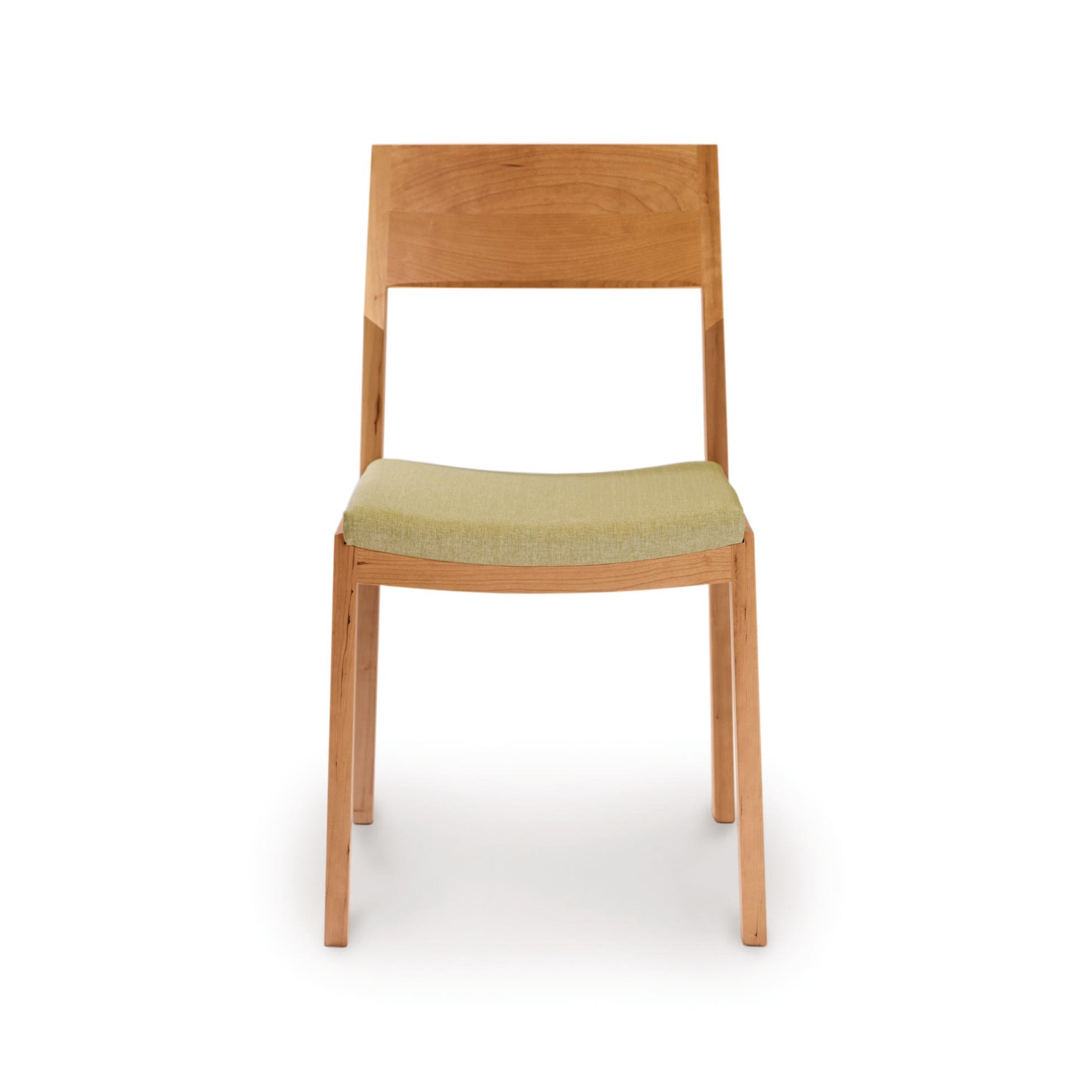 A solid cherry wood Copeland Furniture Iso Chair with a green fabric seat against a white background, crafted from sustainably sourced hardwoods.